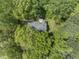 Aerial view of a home nestled among dense green trees, showcasing its secluded location and natural beauty at 4041 Brook Cross Dr, Apex, NC 27539