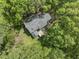 Aerial view of a secluded home surrounded by lush green trees, offering privacy and a natural setting at 4041 Brook Cross Dr, Apex, NC 27539