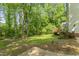 Lush green backyard featuring a wooden deck, ideal for entertaining and enjoying outdoor living at 4041 Brook Cross Dr, Apex, NC 27539
