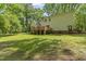 Exterior home view of backyard with patio and mature trees at 4041 Brook Cross Dr, Apex, NC 27539