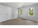 Bedroom featuring light gray walls, windows, and vinyl floors at 4041 Brook Cross Dr, Apex, NC 27539