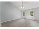 Spacious bedroom with neutral walls, wood-look floors, and two windows for natural light at 4041 Brook Cross Dr, Apex, NC 27539