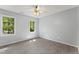 Bedroom featuring gray walls, vinyl floors, and well-lit windows at 4041 Brook Cross Dr, Apex, NC 27539