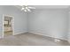 Spacious bedroom with gray walls, ceiling fan, and vinyl flooring at 4041 Brook Cross Dr, Apex, NC 27539