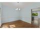 Classic dining room with wood floors, chandelier, light blue walls and natural light at 4041 Brook Cross Dr, Apex, NC 27539