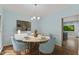 Lovely dining room with stylish chandelier, seating for four, and views of the backyard at 4041 Brook Cross Dr, Apex, NC 27539