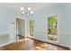 Dining room with light blue walls, hardwood floors, and plenty of natural light at 4041 Brook Cross Dr, Apex, NC 27539