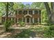 Traditional brick home with black shutters and green lawn shaded by mature trees at 4041 Brook Cross Dr, Apex, NC 27539