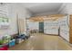 Spacious garage featuring shelving, lighting, and a high ceiling at 4041 Brook Cross Dr, Apex, NC 27539