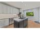 Updated kitchen with granite counters, a large island, stainless steel appliances and a view of the backyard at 4041 Brook Cross Dr, Apex, NC 27539