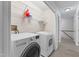 Laundry room with washer, dryer, wire shelves, and vinyl flooring at 4041 Brook Cross Dr, Apex, NC 27539