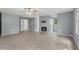 Open-concept living room with gray walls, vinyl flooring, and a ceiling fan at 4041 Brook Cross Dr, Apex, NC 27539