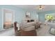 Comfortable living room featuring plush seating, a ceiling fan, and stylish decor at 4041 Brook Cross Dr, Apex, NC 27539
