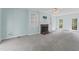 Bright living room featuring a fireplace, built-in shelves, and scenic views through the windows at 4041 Brook Cross Dr, Apex, NC 27539