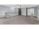 Spacious loft featuring vinyl flooring, white railings, and a ceiling fan at 4041 Brook Cross Dr, Apex, NC 27539