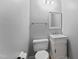 Neat powder room featuring stylish vanity, toilet, mirror, and lighting at 4041 Brook Cross Dr, Apex, NC 27539