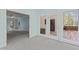 Sunroom with light blue walls leading to a carpeted room and featuring deck access at 4041 Brook Cross Dr, Apex, NC 27539