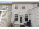 Enclosed backyard with white siding, a door to the backyard, and a small patio with furniture at 412 Stone Flower Ln, Raleigh, NC 27603
