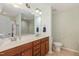 Bathroom featuring a double sink vanity, large mirror, and shower with glass door at 412 Stone Flower Ln, Raleigh, NC 27603