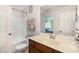 Bathroom featuring a vanity with a solid surface countertop, white fixtures and tub and shower combo at 412 Stone Flower Ln, Raleigh, NC 27603