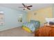 Bright bedroom features a ceiling fan, carpet and a large window at 412 Stone Flower Ln, Raleigh, NC 27603