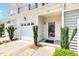 A bright, inviting entrance with a glass front door and neatly trimmed bushes at 412 Stone Flower Ln, Raleigh, NC 27603