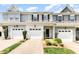 A charming townhouse with a one-car garage and well-manicured landscaping at 412 Stone Flower Ln, Raleigh, NC 27603