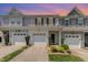Charming townhome featuring a one-car garage, inviting front entrance, and meticulously landscaped yard at 412 Stone Flower Ln, Raleigh, NC 27603