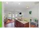 Open concept living area with kitchen bar, hardwood floors and bright natural light at 412 Stone Flower Ln, Raleigh, NC 27603