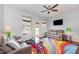 A bright living room with a colorful rug, ceiling fan and natural light at 412 Stone Flower Ln, Raleigh, NC 27603