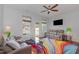 Cozy living room with a ceiling fan, leather furniture, and a colorful area rug at 412 Stone Flower Ln, Raleigh, NC 27603