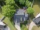 Aerial view of a home showcasing a deck, lush lawn, and beautiful landscaping at 45 Mill Cir, Clayton, NC 27527