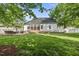 Large backyard with a patio, deck, and mature trees offers ample space for recreation at 45 Mill Cir, Clayton, NC 27527