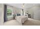 Inviting bedroom featuring neutral walls, plush carpet, and natural light streaming through large windows at 45 Mill Cir, Clayton, NC 27527