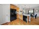 Spacious kitchen with stainless steel appliances, hardwood floors, and an open layout connected to the dining area at 45 Mill Cir, Clayton, NC 27527