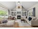 Elegant living room with vaulted ceilings, fireplace, built-in bookshelves, and stylish, comfortable furniture at 45 Mill Cir, Clayton, NC 27527