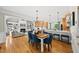 Open-concept kitchen, dining and living area featuring hardwood floors, comfortable seating, and a fireplace at 45 Mill Cir, Clayton, NC 27527