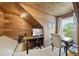 Charming office space with natural wood paneling, built-in shelving, and ample natural light at 45 Mill Cir, Clayton, NC 27527