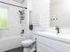 This bathroom features white subway tile on the walls and dark grout, and sleek fixtures at 4521 Briarglen Ln, Holly Springs, NC 27540