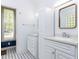 The bathroom features dual sinks, white cabinetry, and blue and white tile at 4521 Briarglen Ln, Holly Springs, NC 27540