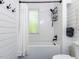 Bright bathroom with white subway tile, modern black fixtures, and stylish shower curtain at 4521 Briarglen Ln, Holly Springs, NC 27540