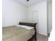 A bedroom offers a light wall color, dark colored wood frame bed, and door access at 4521 Briarglen Ln, Holly Springs, NC 27540