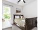A bedroom offers a large window, a light wall color, and a dark colored wood frame bed at 4521 Briarglen Ln, Holly Springs, NC 27540
