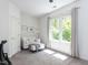 Cozy bedroom with a large window offering natural light and a comfortable white sofa at 4521 Briarglen Ln, Holly Springs, NC 27540