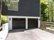 Modern two-car garage with sleek black doors and a well-maintained driveway, adding to the home's curb appeal at 4521 Briarglen Ln, Holly Springs, NC 27540