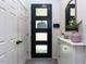 A bright hallway features a stylish front door, ample storage, and modern decor at 4521 Briarglen Ln, Holly Springs, NC 27540