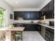 The kitchen features sleek, modern appliances, granite countertops, and ample cabinet space at 4521 Briarglen Ln, Holly Springs, NC 27540