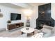 Stylish living room with fireplace, modern furnishings, and a mounted television at 4521 Briarglen Ln, Holly Springs, NC 27540