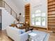 Cozy living room featuring a soaring ceiling, large windows, hardwood floors, and stylish decor at 4521 Briarglen Ln, Holly Springs, NC 27540