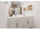 Bright bathroom featuring double sinks, white cabinetry, and a large mirror at 46 S Great White Way, Clayton, NC 27527